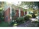 Charming brick home featuring a covered front porch with classic white pillars and mature landscaping at 5127 Murrayhill Rd, Charlotte, NC 28210