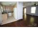 Kitchen view showcases light wood cabinets and essential appliances, seamlessly connected to the living area at 5127 Murrayhill Rd, Charlotte, NC 28210
