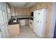 Efficient kitchen features light wood cabinets and essential appliances, ready for your personal touch at 5127 Murrayhill Rd, Charlotte, NC 28210