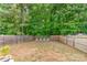 Expansive fenced backyard with mature trees, offering a private outdoor space at 516 Tribune Dr, Charlotte, NC 28214