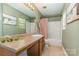 Bathroom featuring a vanity sink with a light brown countertop and a shower/tub combo at 516 Tribune Dr, Charlotte, NC 28214