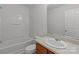 Bathroom featuring a shower-tub combo and a vanity with a sink and wooden cabinet at 5312 Peach Place Ln, Charlotte, NC 28216
