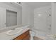 Bathroom featuring a combined tub and shower, and built-in storage at 5312 Peach Place Ln, Charlotte, NC 28216