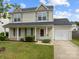 Charming two-story home with front porch and well-manicured lawn at 5312 Peach Place Ln, Charlotte, NC 28216