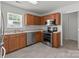 Efficient kitchen with stainless steel appliances, oak cabinets and tile flooring at 5312 Peach Place Ln, Charlotte, NC 28216