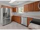 Well-lit kitchen with stainless steel refrigerator and ample counter space at 5312 Peach Place Ln, Charlotte, NC 28216