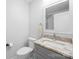 Modern bathroom featuring a granite countertop, gray cabinets, and a mirror over the sink at 5615 American Way, Denver, NC 28037