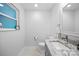 Stylish half bathroom featuring a granite countertop, gray cabinets and lovely decor at 5615 American Way, Denver, NC 28037