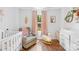 Charming Bedroom with hardwood floors, crib, chair and plenty of natural light at 5615 American Way, Denver, NC 28037