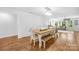 Bright dining room features a rustic table and bench with views to the living area at 5615 American Way, Denver, NC 28037