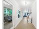 Bright hallway with white walls and tile floors, and a view of the porch and backyard at 5615 American Way, Denver, NC 28037