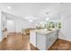 Open kitchen with a large island bar flows into the dining and living areas at 5615 American Way, Denver, NC 28037