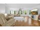 Bright living room boasts hardwood floors, multiple windows, and comfortable seating at 5615 American Way, Denver, NC 28037