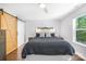 Bright main bedroom features barn door, ceiling fan and decorative headboard at 5615 American Way, Denver, NC 28037