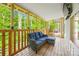 Inviting screened-in porch featuring comfortable wicker seating and a scenic view of the surrounding greenery at 5615 American Way, Denver, NC 28037