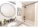 Modern bathroom showcasing a round mirror, sleek vanity, tiled shower, and black fixtures for a contemporary aesthetic at 6501 Piney Path Rd, Charlotte, NC 28212