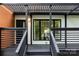 Inviting front porch with black railings, natural wood accents, and stylish lighting, creating a welcoming outdoor space at 6501 Piney Path Rd, Charlotte, NC 28212