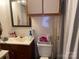 A functional bathroom features a vanity with a sink, a mirror, and cabinet space for storage at 6504 Denver Heights Cir, Denver, NC 28037