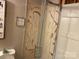 A bathroom featuring shower stall with a patterned door and toilet with playful wall decor at 6504 Denver Heights Cir, Denver, NC 28037