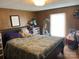 View of bedroom features window with blinds, wood paneled walls, and is comfortably furnished at 6504 Denver Heights Cir, Denver, NC 28037
