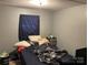 Relaxing bedroom featuring natural light with privacy from a blue curtain and comfortable bed at 6504 Denver Heights Cir, Denver, NC 28037