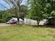 Home with neutral siding, an attached garage, and a truck and van parked on a grassy lawn at 6504 Denver Heights Cir, Denver, NC 28037