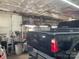 Garage interior with black truck featuring tool box, and shelving for storage, work area at 6504 Denver Heights Cir, Denver, NC 28037