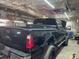 Garage interior features a black truck with tool box, and storage for a workshop setting at 6504 Denver Heights Cir, Denver, NC 28037