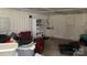 A cluttered utility interior features storage boxes, a window, white walls and gray concrete floor at 6504 Denver Heights Cir, Denver, NC 28037