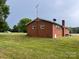 Back exterior view of brick home with well-maintained lawn at 675 E Ritchie Rd, Salisbury, NC 28146