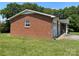 Angled view of the brick home featuring an attached two-car garage, and a covered front porch at 675 E Ritchie Rd, Salisbury, NC 28146