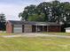 Charming single-story brick home featuring a two-car garage and a well-maintained front yard at 675 E Ritchie Rd, Salisbury, NC 28146