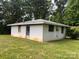 The home has a simple one-story design with a flat, gray roof, white brick, and a clean, grassy yard with minimal landscaping at 675 E Ritchie Rd, Salisbury, NC 28146