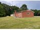 Back exterior view of brick home with a sprawling lawn at 675 E Ritchie Rd, Salisbury, NC 28146