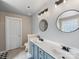 Bathroom features a double sink vanity, round mirrors and decorative lighting at 6909 Dunton St, Huntersville, NC 28078