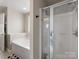 Bathroom showcasing a tub, shower, and modern fixtures at 6909 Dunton St, Huntersville, NC 28078
