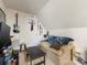 Cozy bedroom with sloped ceilings, a comfortable couch, and quirky decor creating a unique and inviting space at 6909 Dunton St, Huntersville, NC 28078