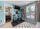 Bedroom features bright walls, a Peloton bike, and a view of the outside at 6909 Dunton St, Huntersville, NC 28078