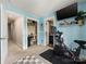 Bedroom with blue walls, Peloton bike, tv and ensuite bath at 6909 Dunton St, Huntersville, NC 28078
