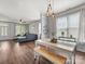 Bright dining area with modern light fixtures open to the living room at 6909 Dunton St, Huntersville, NC 28078