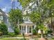 Two-story home with a cozy front porch, green lawn and mature landscaping at 6909 Dunton St, Huntersville, NC 28078