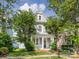 Charming two-story home featuring a cozy front porch and lush landscaping at 6909 Dunton St, Huntersville, NC 28078