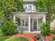 Inviting front porch features classic white columns and offers a relaxing entry at 6909 Dunton St, Huntersville, NC 28078