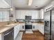 Well-lit kitchen with stainless steel appliances, including a refrigerator and oven, complemented by white cabinets and countertops at 6909 Dunton St, Huntersville, NC 28078
