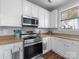 Close-up shot showcasing stainless steel oven and microwave against a backdrop of white cabinets and neutral countertops at 6909 Dunton St, Huntersville, NC 28078