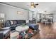 Inviting living room with a gray sectional sofa, accent chairs, and hardwood floors at 6909 Dunton St, Huntersville, NC 28078