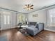 Open-concept living room with a comfortable gray sofa and lots of natural light at 6909 Dunton St, Huntersville, NC 28078