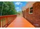 A wooden deck stretches out from a brick home and extends into a green backyard at 707 Hester Dr, Dallas, NC 28034