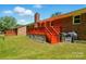 A lovely outdoor deck extends from a brick home into a lush, green yard at 707 Hester Dr, Dallas, NC 28034