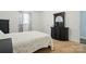 Cozy bedroom featuring a comfortable bed, a dresser, and natural light from the window at 707 Hester Dr, Dallas, NC 28034